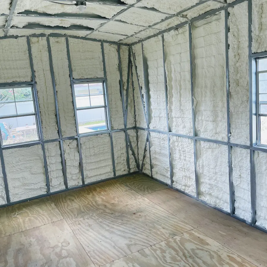 Closed-cell spray foam insulation applied to wall cavities in a residential project in Sandy